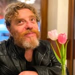 Portrait of Seani, a facilitator at the Happie Together Festival, embodying warmth and depth while supporting relational exploration in a tantra and kink festival setting.